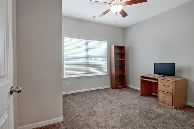 a view of a livingroom with workspace and a window
