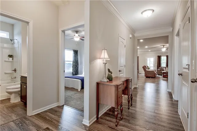 a view of a hallway with wooden floor windows and a livingroom