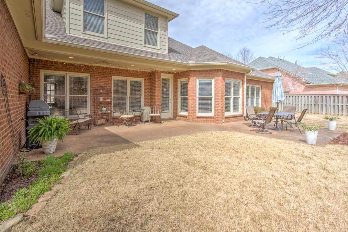 9465 Johnson Rd Extension Germantown, TN 38139 - Photo 23 of 25 The backyard features a covered porch area + an open patio.