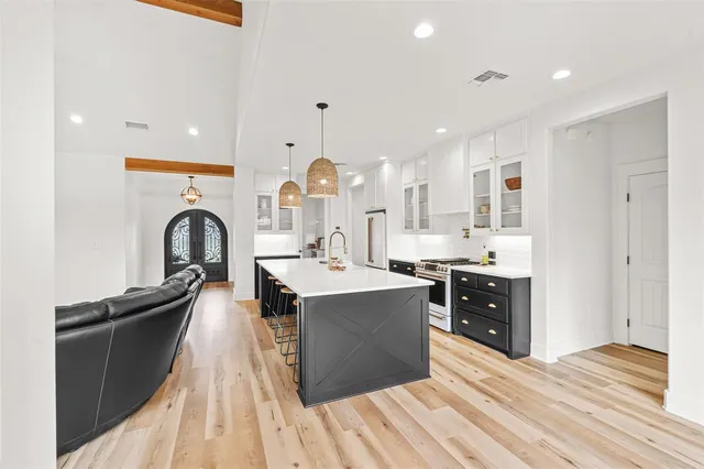 a kitchen with stainless steel appliances granite countertop a sink stove and refrigerator