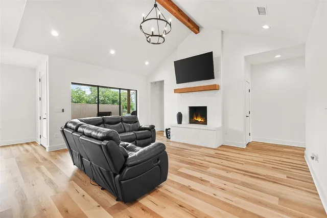 a living room with furniture flat screen tv and a fireplace