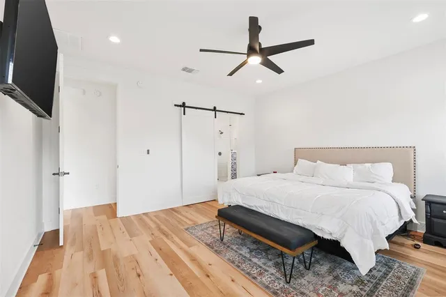 a bedroom with a bed and a flat screen tv