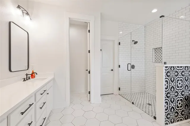a spacious bathroom with a double vanity sink mirror and double