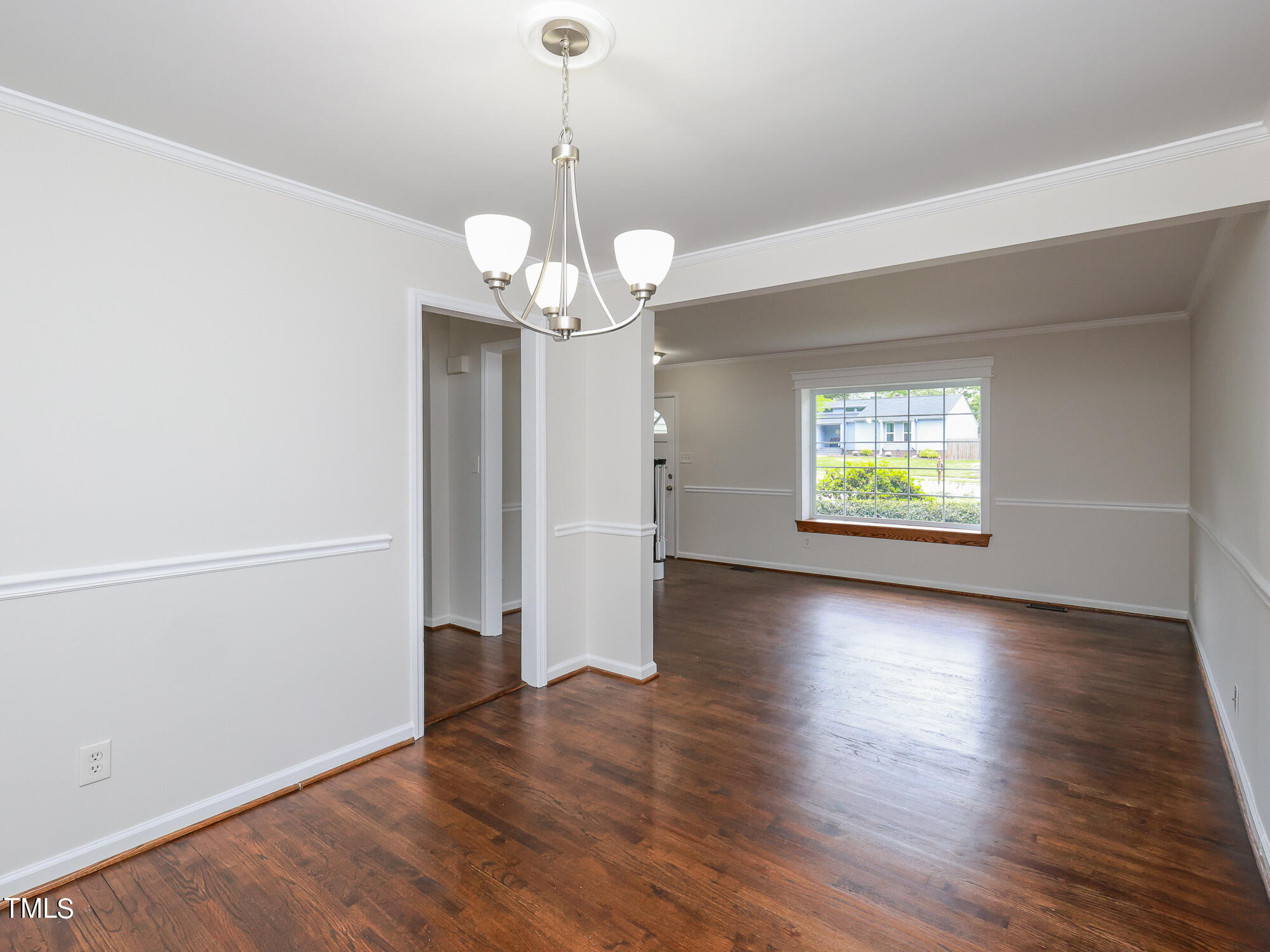 7208 Mine Shaft Road Raleigh, NC 27615 - Photo 3 of 29 a view of an empty room with wooden floor and a window