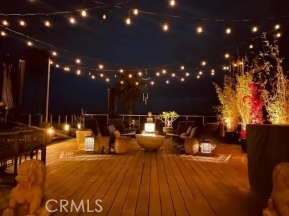 a view of a patio with dining table and chairs with wooden floor