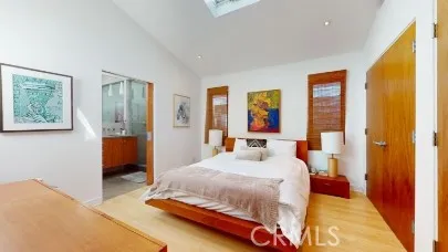 a bedroom with a bed and a painting on the wall