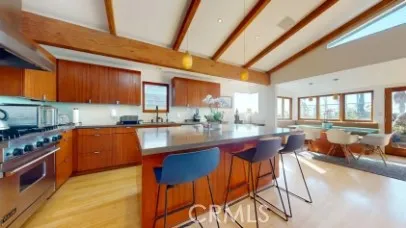 a kitchen with stainless steel appliances granite countertop wooden cabinets a sink and a stove