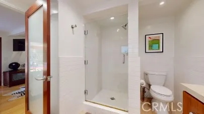 a bathroom with a toilet and a shower