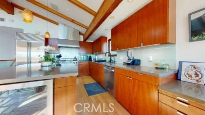 a kitchen with stainless steel appliances granite countertop a refrigerator a stove and a sink