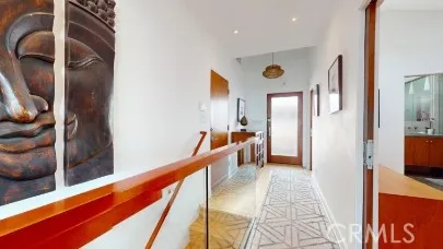 a view of a hallway with wooden floor and furniture