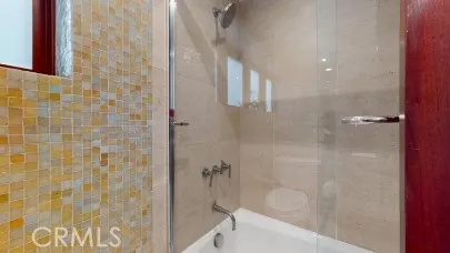 a bathroom with a bathtub and shower