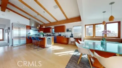 a kitchen with stainless steel appliances kitchen island granite countertop a refrigerator a stove and a sink with dishwasher