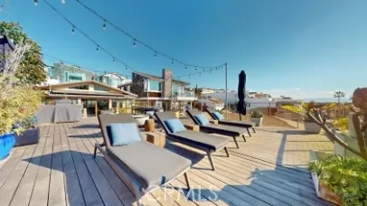 a view of a chairs and table on the wooden deck