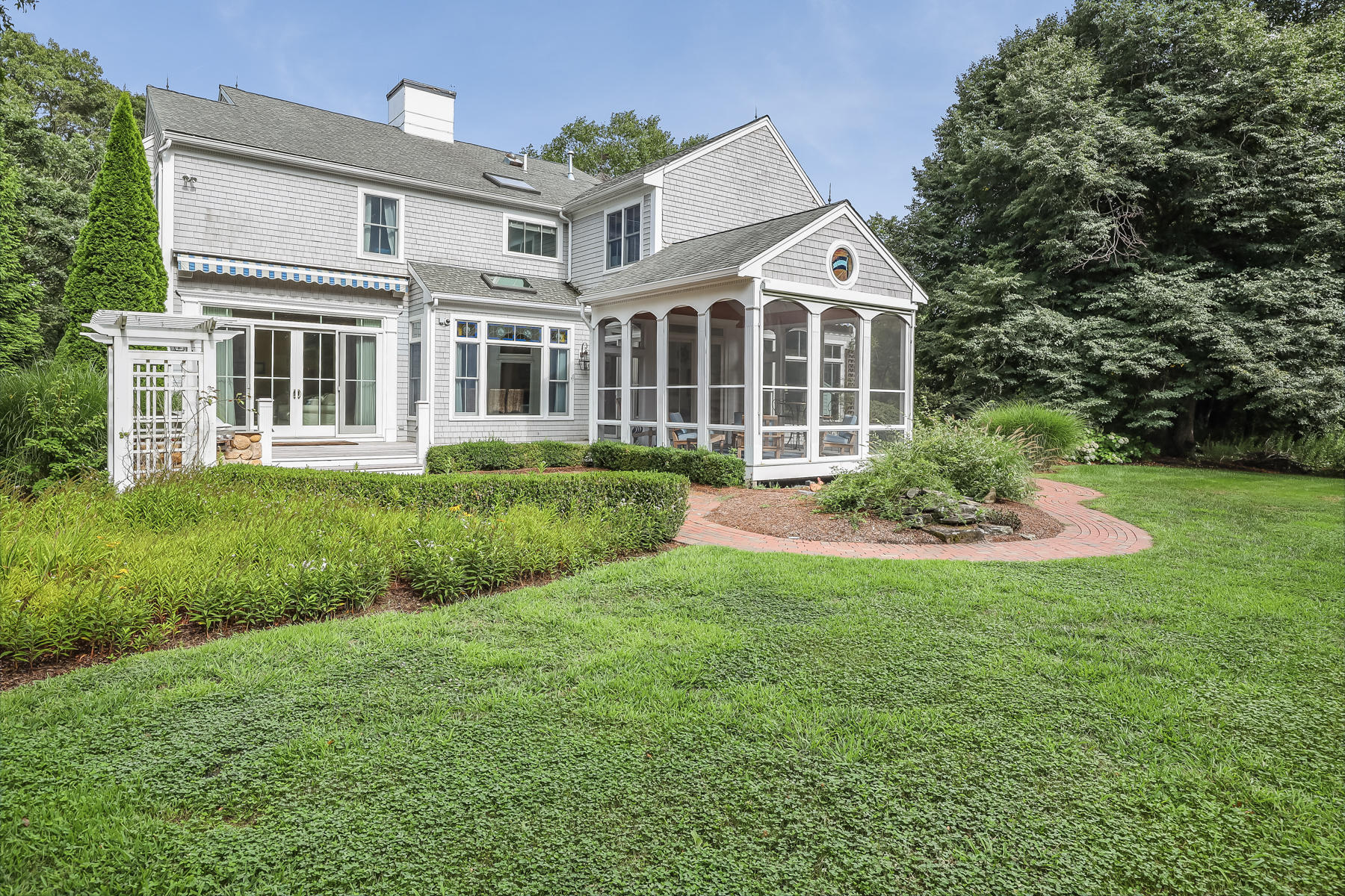 51 Meadow Farm Road Centerville, MA 02632 - Photo 35 of 45 a front view of a house with a yard and green space