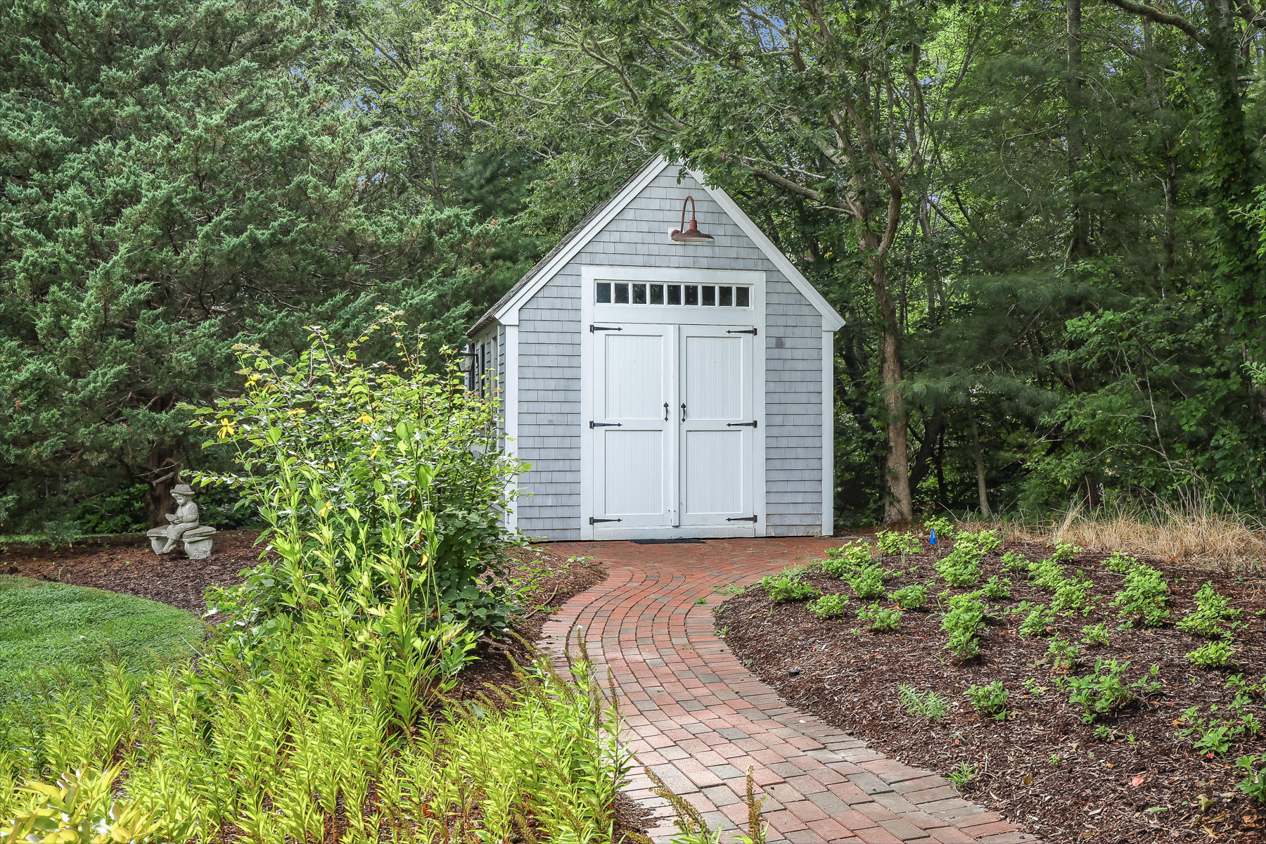 51 Meadow Farm Road Centerville, MA 02632 - Photo 38 of 45 a view of a garage with a small yard