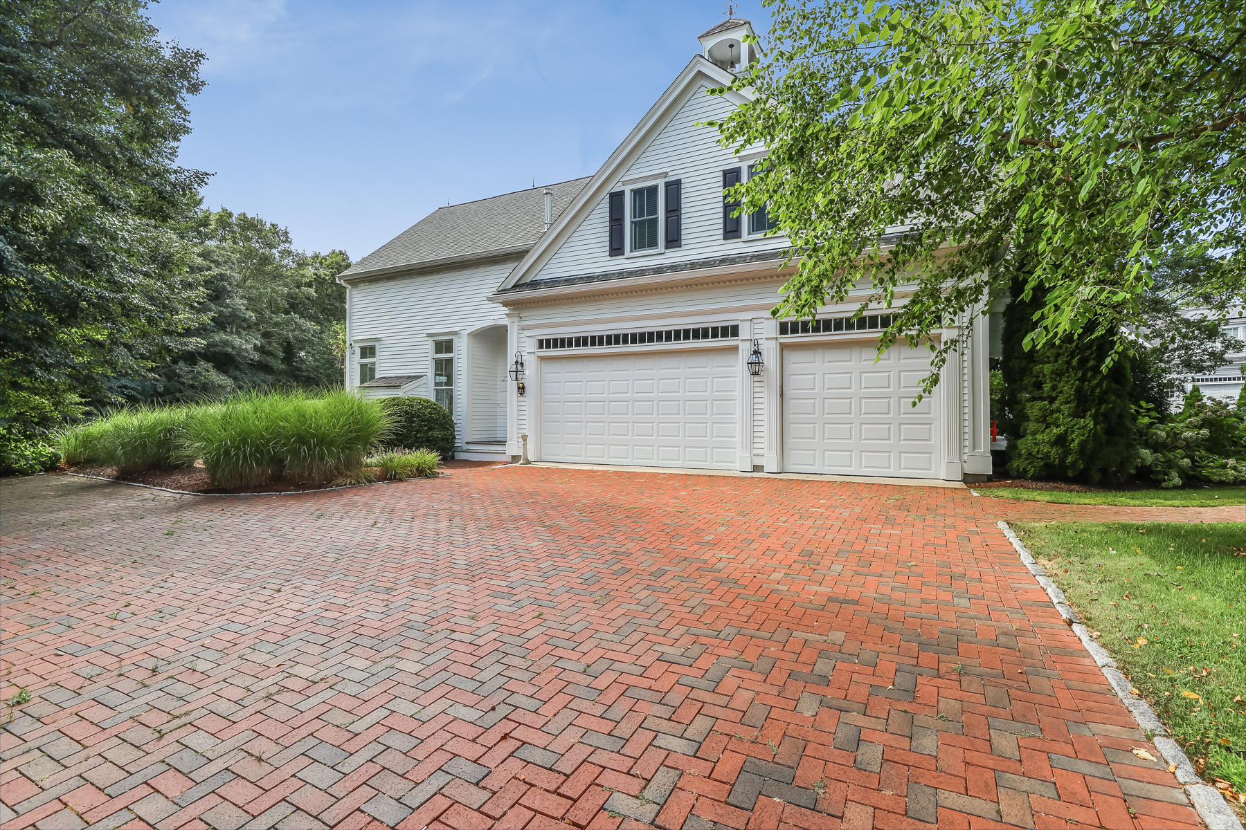 51 Meadow Farm Road Centerville, MA 02632 - Photo 42 of 45 a front view of a house with a yard and garage