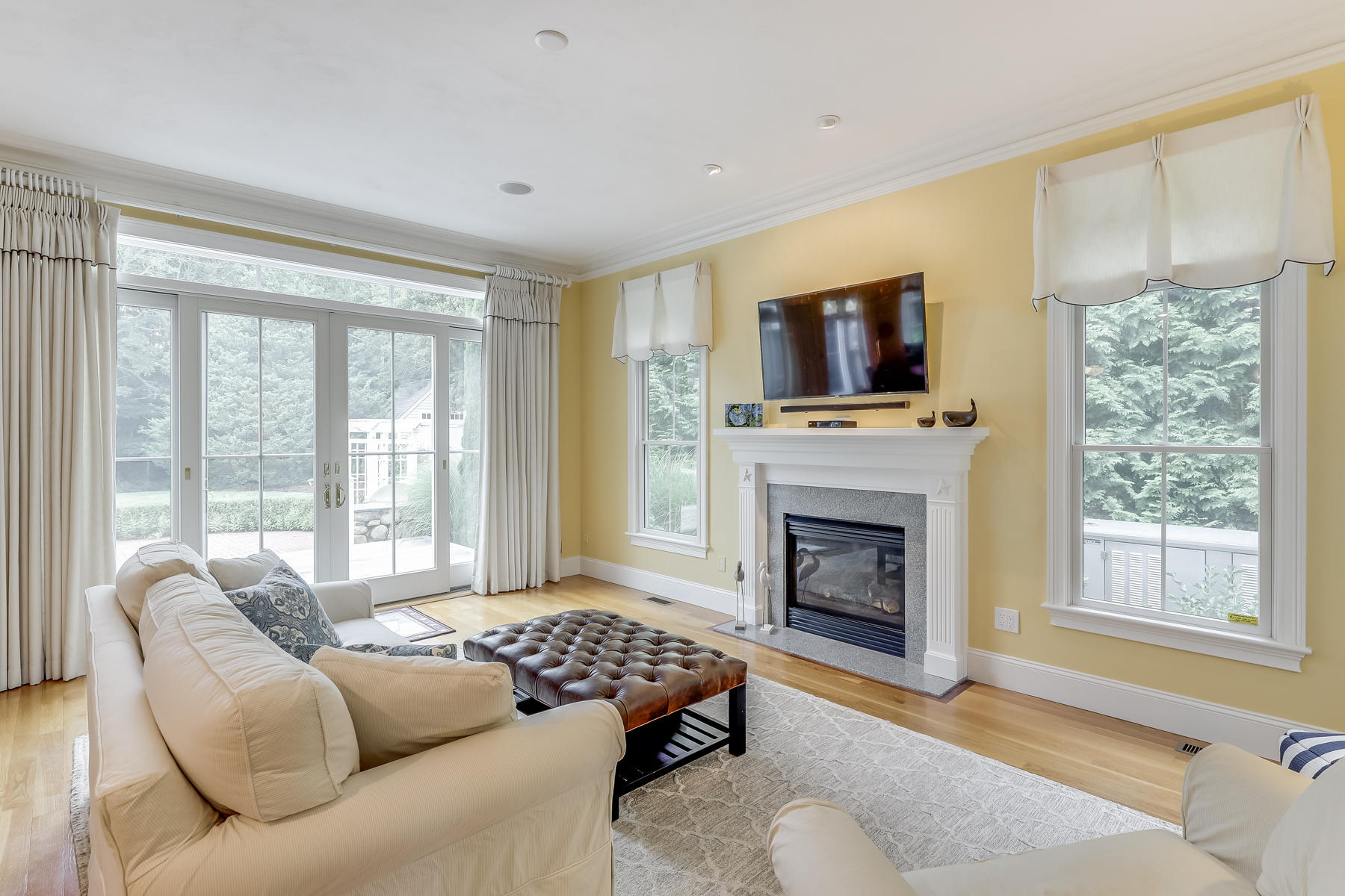 51 Meadow Farm Road Centerville, MA 02632 - Photo 6 of 45 a living room with furniture a flat screen tv and a fireplace