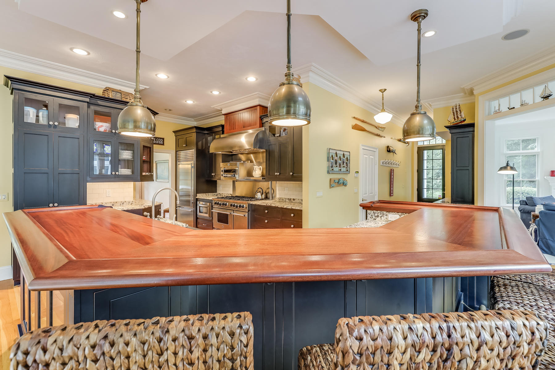 51 Meadow Farm Road Centerville, MA 02632 - Photo 8 of 45 a room with kitchen island a chandelier and fireplace