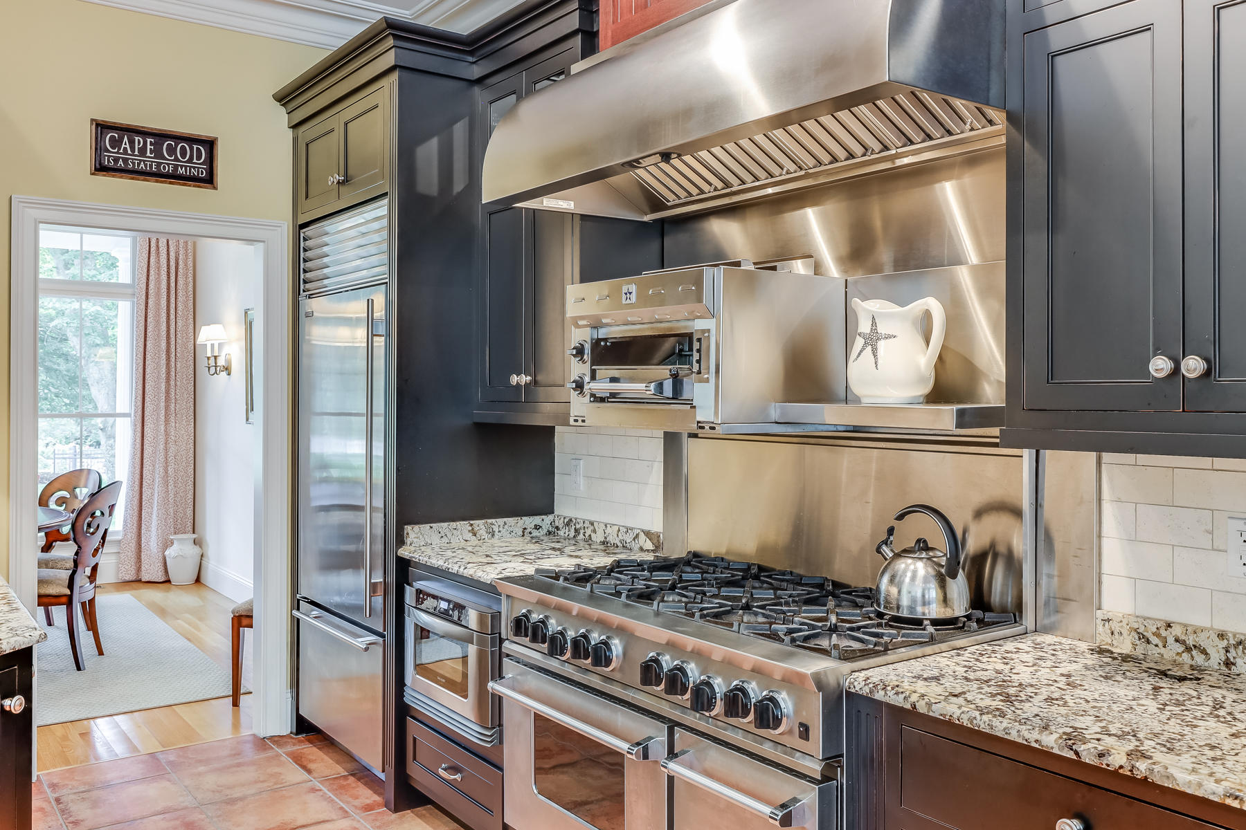 51 Meadow Farm Road Centerville, MA 02632 - Photo 10 of 45 a kitchen with a stove and a wooden floor