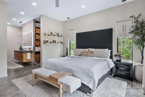 a bedroom with a bed and a flat screen tv