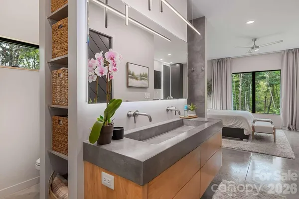 a bathroom with a sink mirror and toilet