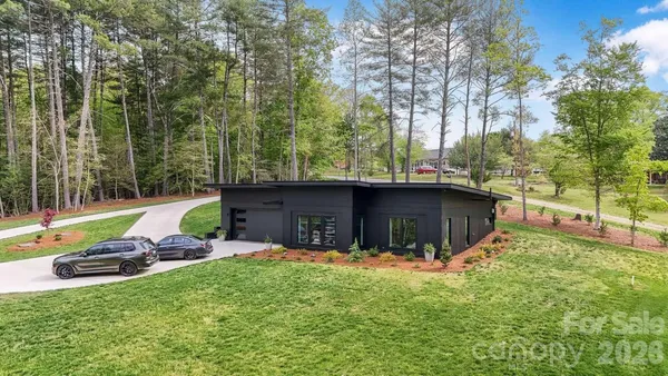 a view of a backyard with a garden and fire pit