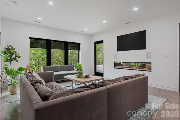 a living room with furniture tv and a large window