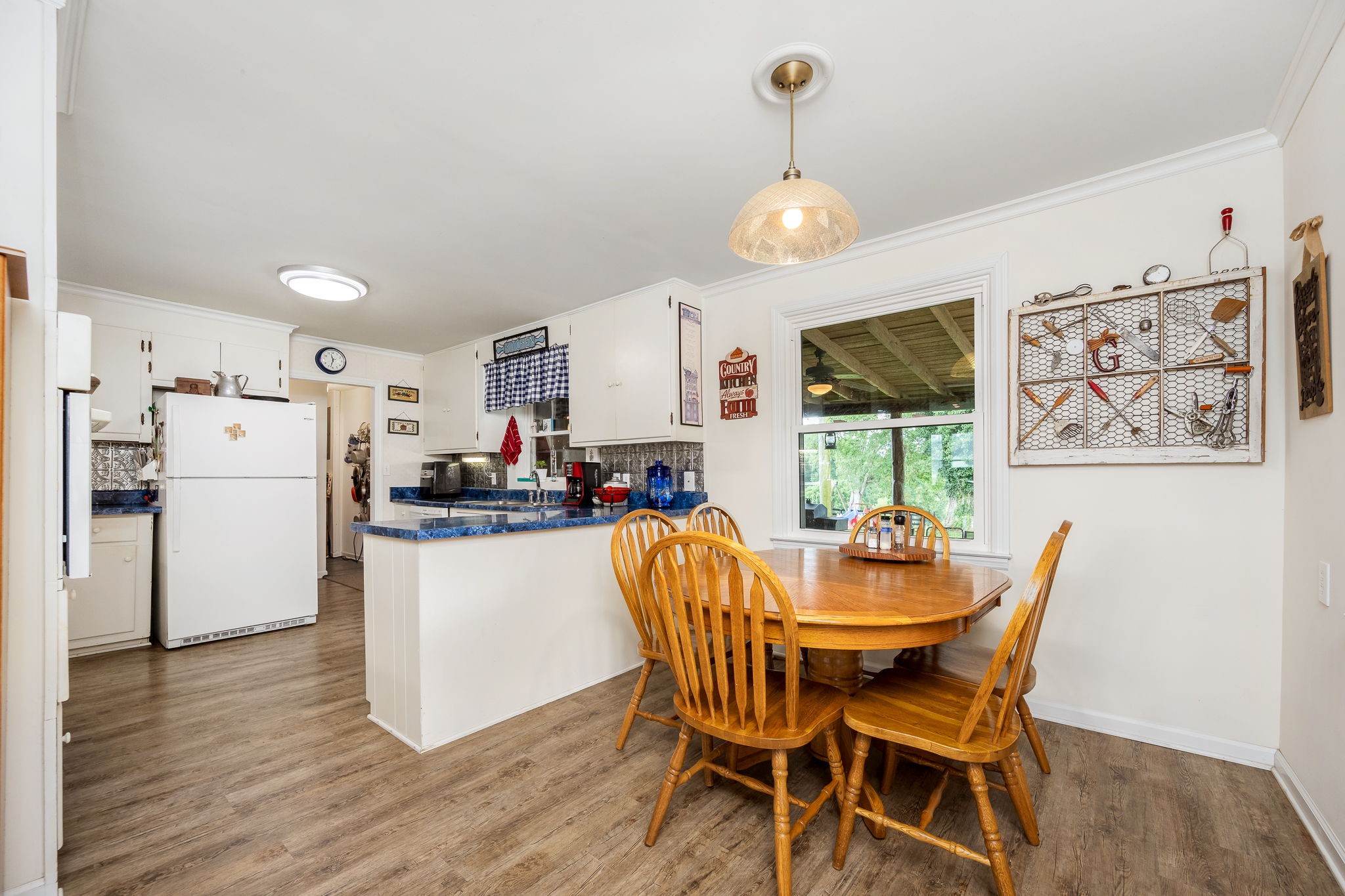 540 Powell Hollow Road Tullahoma, TN 37388 - Photo 21 of 83 a dining room with stainless steel appliances kitchen island granite countertop a table chairs and a refrigerator