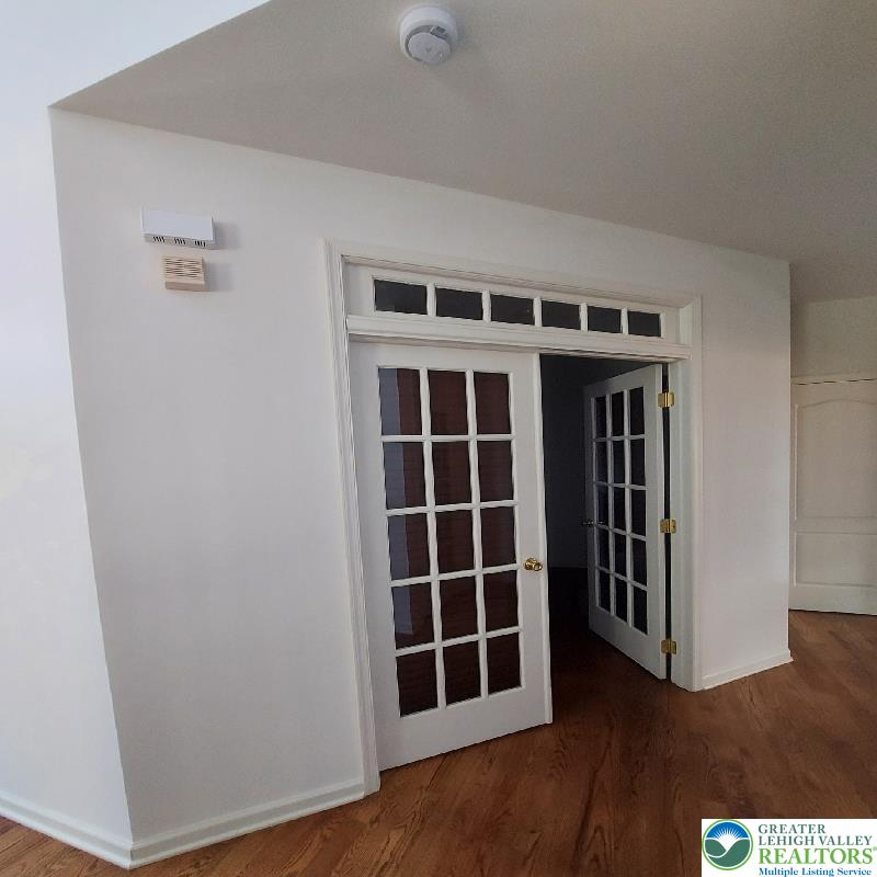 4704 Reston Drive Easton, PA 18040 - Photo 11 of 32 a view of an empty room with wooden floor and windows
