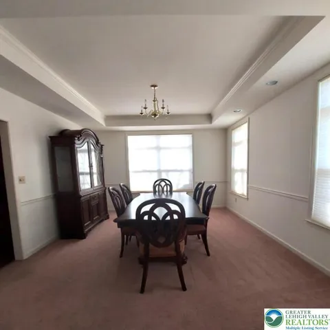 a view of a dining room with furniture and window