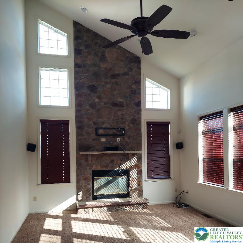 4704 Reston Drive Easton, PA 18040 - Photo 21 of 32 a living room with furniture a window and a fireplace