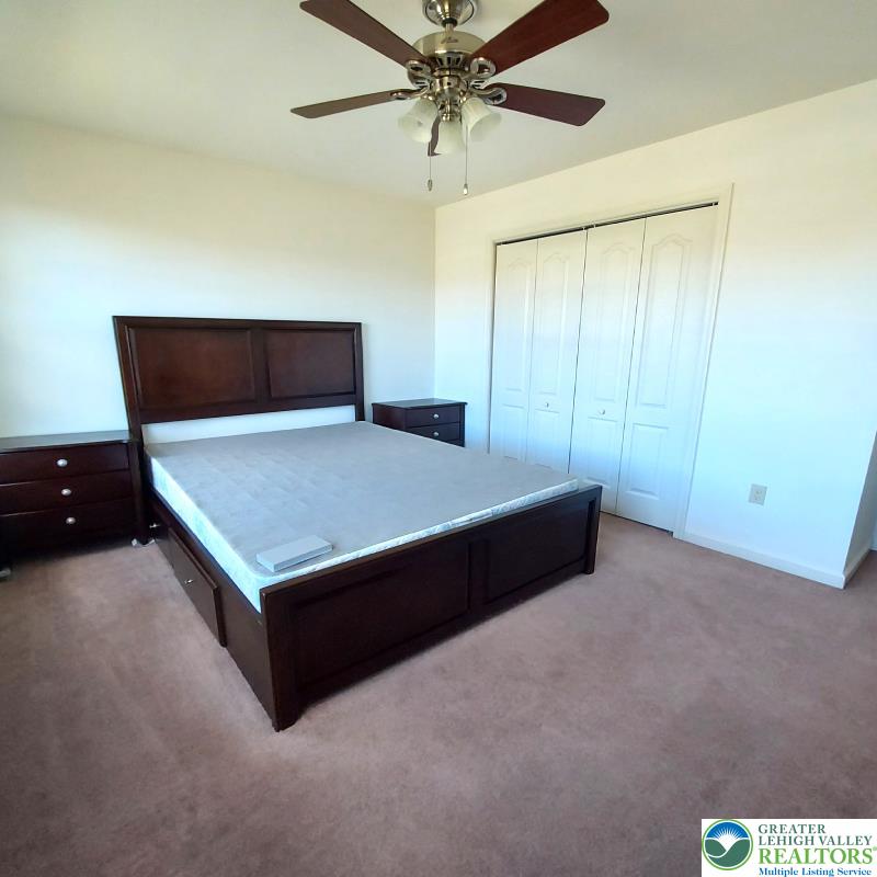 4704 Reston Drive Easton, PA 18040 - Photo 27 of 32 a room with a bed and a chandelier