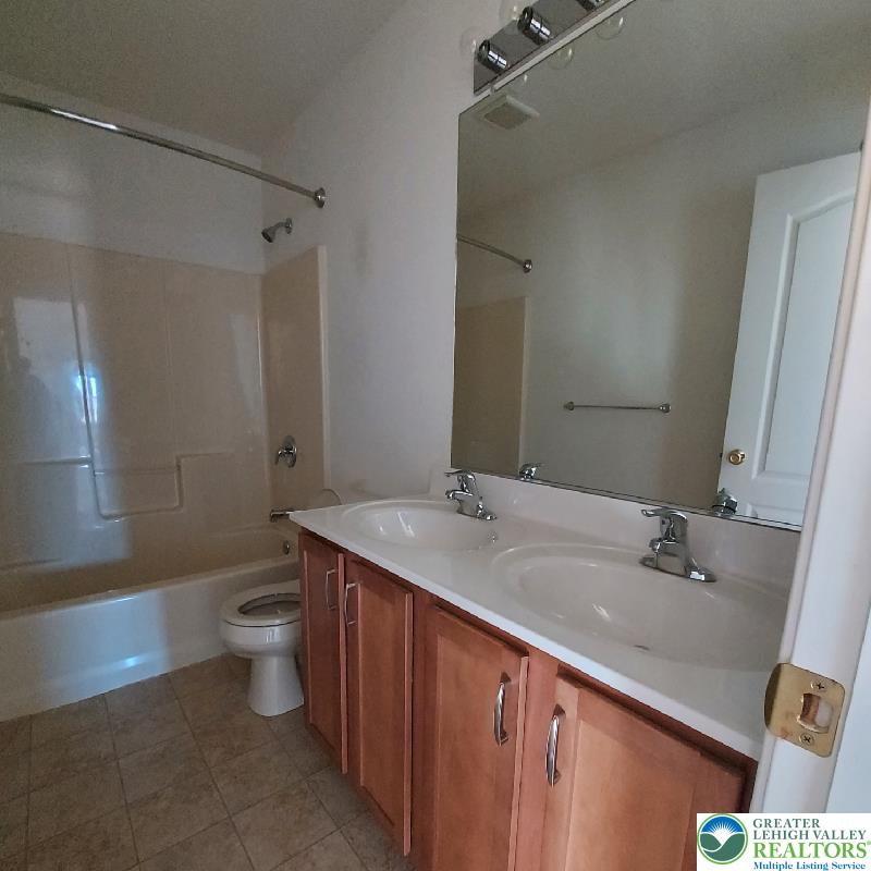 4704 Reston Drive Easton, PA 18040 - Photo 28 of 32 a bathroom with a sink a toilet a mirror and shower
