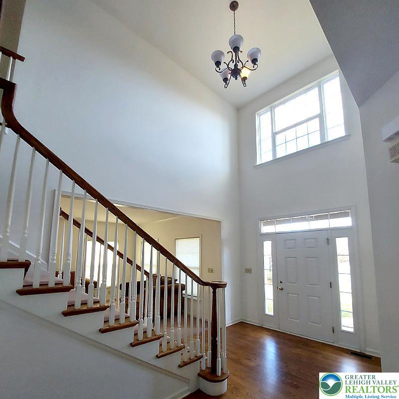 4704 Reston Drive Easton, PA 18040 - Photo 6 of 32 a view of staircase with railing and a chandelier