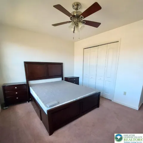 a room with a table and a ceiling fan