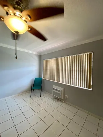 a view of an empty room and a window