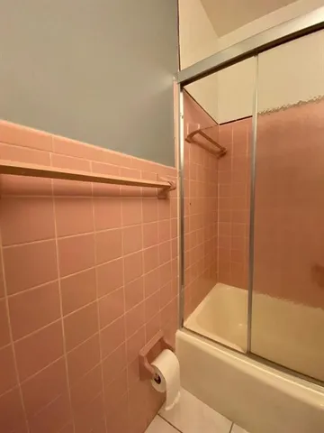 a bathroom with a shower and a shower