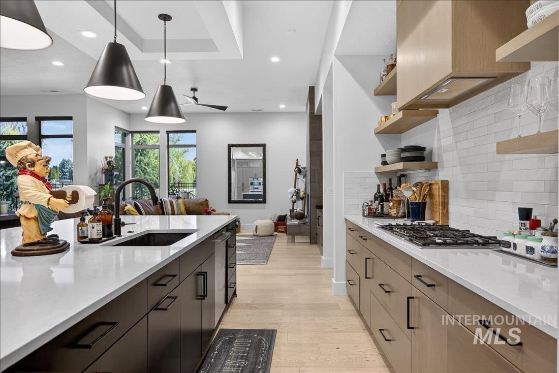 4718 East Goldstone Drive Meridian, ID 83642 - Photo 50 of 50 Kitchen featuring light stone countertops, light wood finished floors, open floor plan, pendant lighting, and open shelves