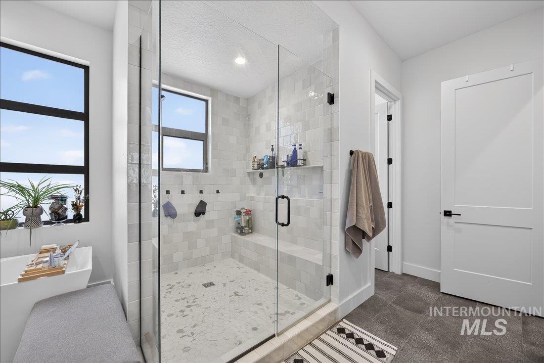 4718 East Goldstone Drive Meridian, ID 83642 - Photo 23 of 50 Bathroom with a shower stall and a freestanding bath