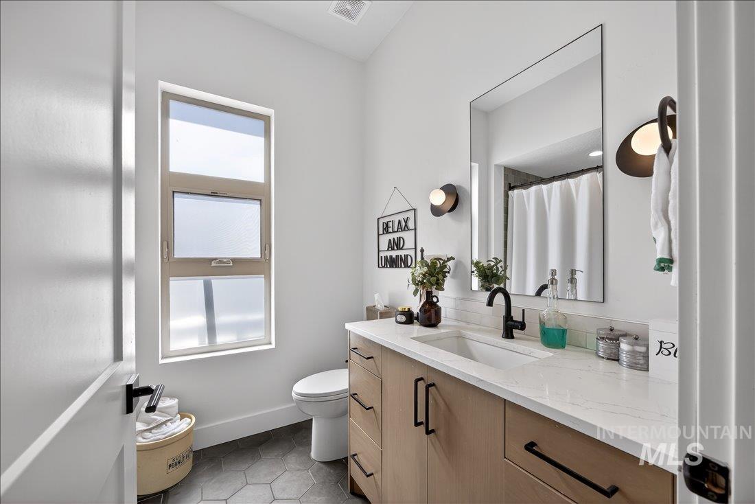 4718 East Goldstone Drive Meridian, ID 83642 - Photo 26 of 50 Bathroom featuring vanity, curtained shower, and light tile patterned floors