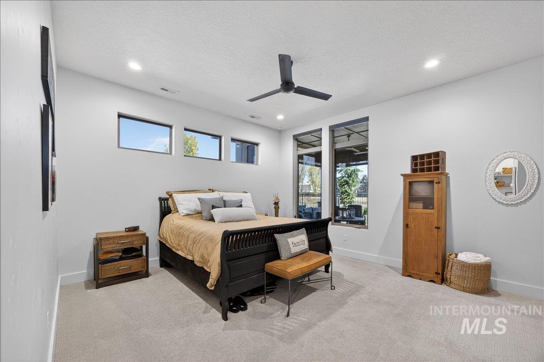 4718 East Goldstone Drive Meridian, ID 83642 - Photo 27 of 50 Bedroom with carpet floors, multiple windows, a textured ceiling, ceiling fan, and recessed lighting