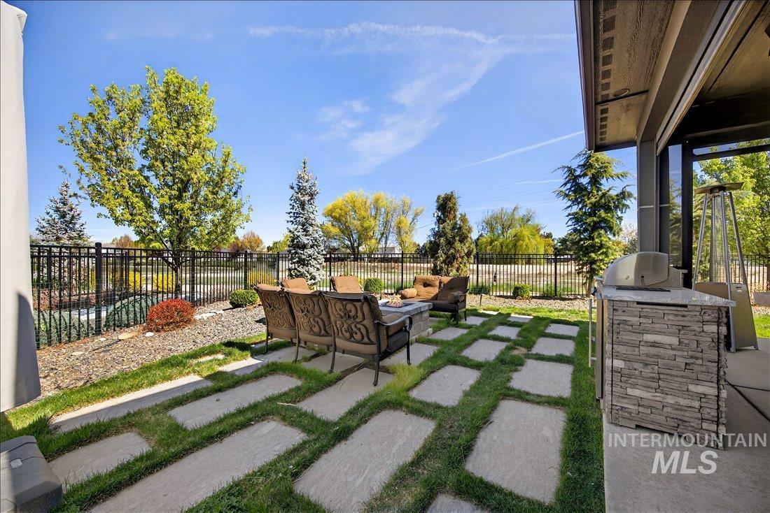 4718 East Goldstone Drive Meridian, ID 83642 - Photo 39 of 50 Fenced backyard with an outdoor kitchen with living area and a patio