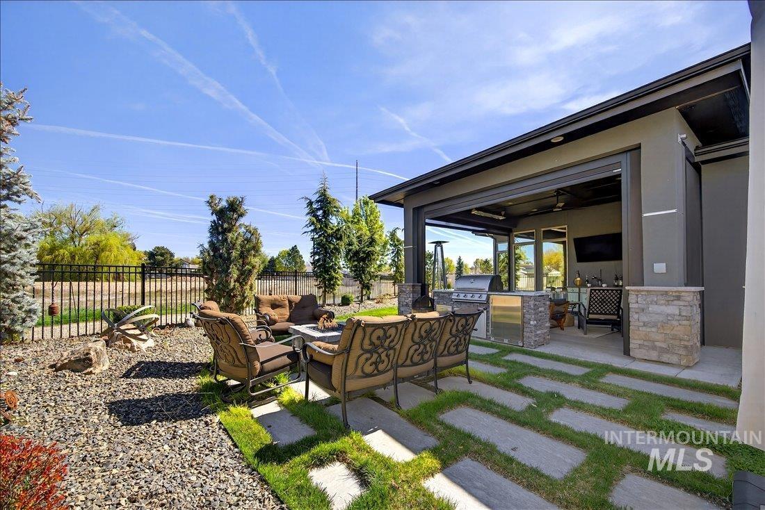 4718 East Goldstone Drive Meridian, ID 83642 - Photo 40 of 50 View of yard with an outdoor kitchen with living area and a patio area