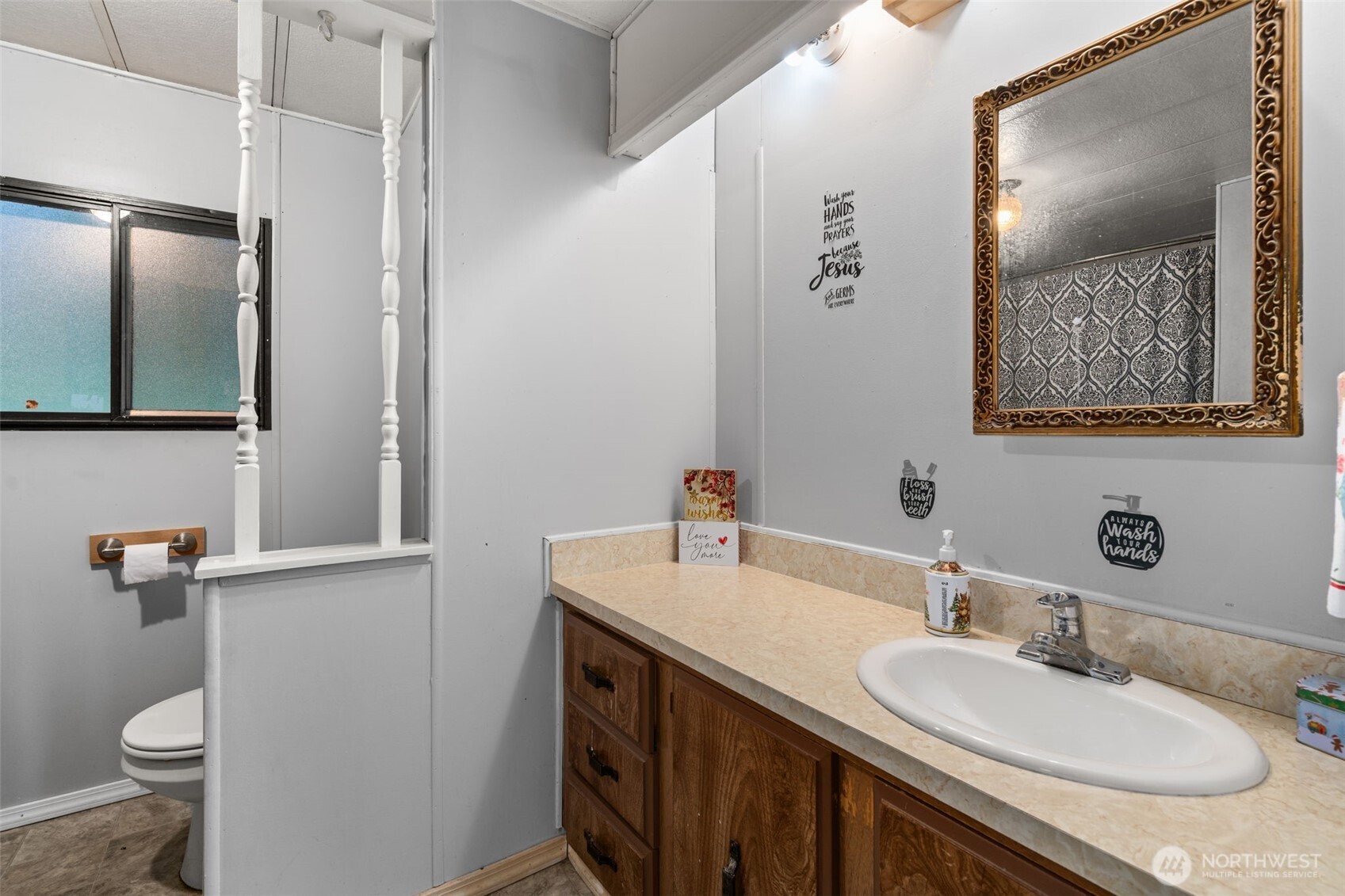 4692 Sherman Heights Road Bremerton, WA 98312 - Photo 16 of 28 a bathroom with a granite countertop sink toilet and mirror