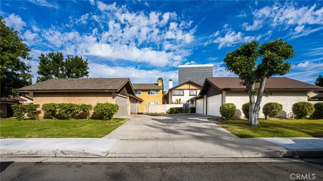 a front view of a house with a yard and a garage