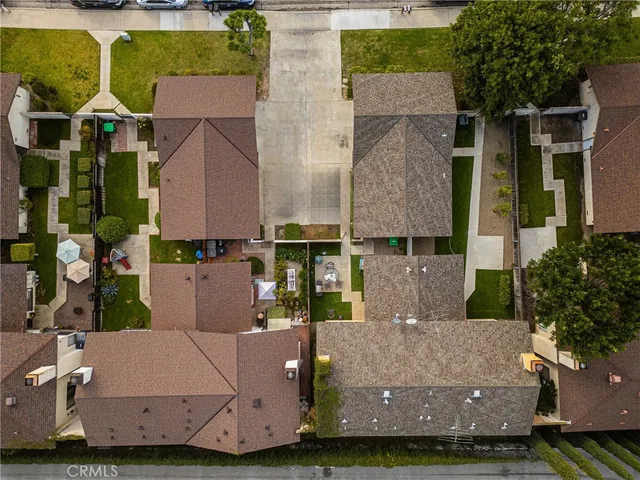 an aerial view of houses with a yard