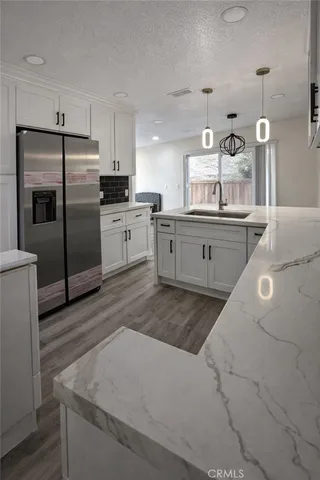 a large kitchen with cabinets stainless steel appliances and a counter space