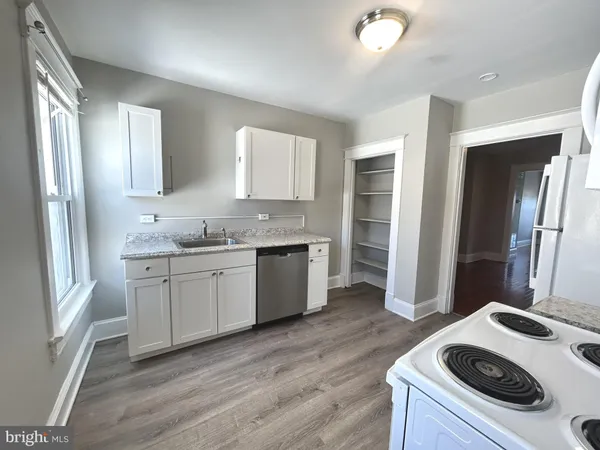 a kitchen with a sink stove and refrigerator