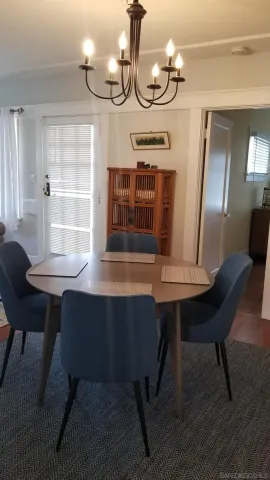 a room with table chairs and wooden floor