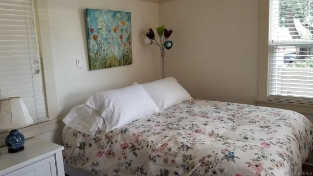 a bedroom with a bed and a window